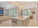Open kitchen with large island, microwave, and living room view at 121 Seagull Ln, Sarasota, FL 34236
