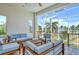 Relaxing lanai with outdoor furniture and ocean view at 121 Seagull Ln, Sarasota, FL 34236