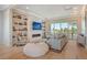 Spacious living room with fireplace and built-in shelving, offering water views at 121 Seagull Ln, Sarasota, FL 34236