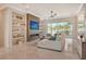 Spacious living area with fireplace, large sectional sofa and water view at 121 Seagull Ln, Sarasota, FL 34236