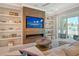 Modern living room with built-in shelving and electric fireplace at 121 Seagull Ln, Sarasota, FL 34236