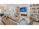 Light-filled living room with fireplace and built-in shelving units at 121 Seagull Ln, Sarasota, FL 34236