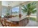 Outdoor kitchen with stainless steel appliances and marble countertops at 121 Seagull Ln, Sarasota, FL 34236