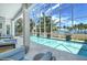 Enclosed pool and patio area with seating and stunning water views at 121 Seagull Ln, Sarasota, FL 34236