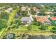 Aerial view of a house community with lush landscaping and a lake at 4452 Mcintosh Lake Ave, Sarasota, FL 34233