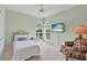 Cozy bedroom with twin bed and window seating at 4452 Mcintosh Lake Ave, Sarasota, FL 34233