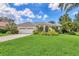 Single-Gathering home with a tile roof and lush landscaping at 4452 Mcintosh Lake Ave, Sarasota, FL 34233