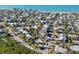 Coastal home aerial view near the beach with tropical landscaping and neighborhood charm at 8010 Marina Dr, Holmes Beach, FL 34217