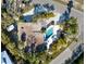 Aerial view of a home featuring a private pool, surrounded by palm trees and lush landscaping at 8010 Marina Dr, Holmes Beach, FL 34217