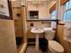 Bathroom featuring a pedestal sink, toilet and tile shower with glass door at 8010 Marina Dr, Holmes Beach, FL 34217
