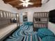Bedroom featuring bunkbeds, a blue patterned rug, and blue bean bag chairs at 8010 Marina Dr, Holmes Beach, FL 34217