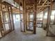 Interior view of a home under construction, displaying exposed framing and electrical work, with large windows in the background at 8010 Marina Dr, Holmes Beach, FL 34217