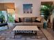 Cozy living room with patterned rug, gray sofa, and view to the outside at 8010 Marina Dr, Holmes Beach, FL 34217