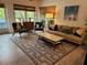 Stylish living room with modern furniture, geometric rug, and natural light creating a cozy ambiance at 8010 Marina Dr, Holmes Beach, FL 34217