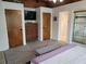 Spacious main bedroom with TV, wooden doors, and ensuite bath entrance at 8010 Marina Dr, Holmes Beach, FL 34217