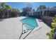 Inviting pool with turquoise water, surrounded by a concrete patio and lush tropical landscaping on a sunny day at 8010 Marina Dr, Holmes Beach, FL 34217