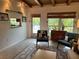 Living room boasts mid-century modern furniture and access to the pool area at 8010 Marina Dr, Holmes Beach, FL 34217