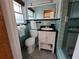 Clean bathroom with a teal tiled shower and modern vanity at 8010 Marina Dr, Holmes Beach, FL 34217
