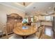 Bright dining area adjacent to kitchen, featuring wooden table and chairs at 13202 Torresina Ter, Bradenton, FL 34211