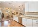 Kitchen with granite countertops, white cabinets, and a view to the dining area at 13202 Torresina Ter, Bradenton, FL 34211