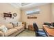 Home office features a comfortable couch and a workspace with built-in shelving at 13202 Torresina Ter, Bradenton, FL 34211