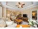 Bright living room featuring hardwood floors, comfy seating, and a large TV at 13202 Torresina Ter, Bradenton, FL 34211