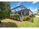 Private backyard oasis with lush landscaping and screened enclosure at 13202 Torresina Ter, Bradenton, FL 34211