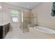 Bathroom with walk-in shower, soaking tub, and double vanity at 5209 Lake Overlook Ave, Bradenton, FL 34208
