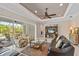 Spacious living room with leather sofas, a large TV, and sliding glass doors leading to a pool at 5209 Lake Overlook Ave, Bradenton, FL 34208