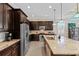 Modern kitchen features stainless steel appliances and dark wood cabinetry at 5209 Lake Overlook Ave, Bradenton, FL 34208