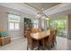 Spacious dining room with wooden table and wicker chairs, leading to backyard at 5209 Lake Overlook Ave, Bradenton, FL 34208