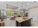 Open concept kitchen with large island, granite countertops, and stainless steel appliances at 5209 Lake Overlook Ave, Bradenton, FL 34208