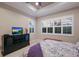 Bedroom with king bed, dresser, and plantation shutters at 5209 Lake Overlook Ave, Bradenton, FL 34208