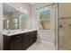 Bathroom with double vanity, walk-in shower, and window at 5209 Lake Overlook Ave, Bradenton, FL 34208