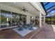 Spacious covered patio with seating area and view of pool at 5209 Lake Overlook Ave, Bradenton, FL 34208