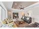 Bright living room featuring leather sofas, a large TV, and access to a pool area at 5209 Lake Overlook Ave, Bradenton, FL 34208