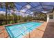Enclosed pool and spa with brick pavers and lush landscaping at 5209 Lake Overlook Ave, Bradenton, FL 34208