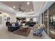 Open concept living area with leather sofas, a view into the kitchen, and access to pool area at 5209 Lake Overlook Ave, Bradenton, FL 34208