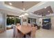 Open concept dining room with wooden table and access to backyard and living room at 5209 Lake Overlook Ave, Bradenton, FL 34208