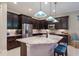 Modern kitchen with dark wood cabinets, granite counters, and stainless steel appliances at 5209 Lake Overlook Ave, Bradenton, FL 34208