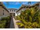 Brick pathway to covered entry with lush landscaping at 5209 Lake Overlook Ave, Bradenton, FL 34208