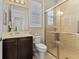 Bathroom with shower, toilet, vanity, and dark brown cabinetry at 5209 Lake Overlook Ave, Bradenton, FL 34208