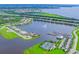 Aerial view of a luxury waterfront community with a marina and tennis courts at 5209 Lake Overlook Ave, Bradenton, FL 34208