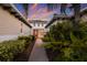 Brick pathway to covered entry with lush landscaping at 5209 Lake Overlook Ave, Bradenton, FL 34208
