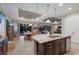Island kitchen with granite countertops, stainless steel appliances, and dark wood cabinetry at 5209 Lake Overlook Ave, Bradenton, FL 34208