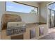 Outdoor kitchen with stainless steel appliances and granite countertops at 5209 Lake Overlook Ave, Bradenton, FL 34208