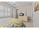 Bedroom with dresser and a queen-size bed with patterned bedding at 5209 Lake Overlook Ave, Bradenton, FL 34208