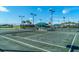 Well-lit tennis courts with covered seating areas at 5209 Lake Overlook Ave, Bradenton, FL 34208