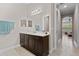 Bathroom with double vanity and view into bedroom at 5209 Lake Overlook Ave, Bradenton, FL 34208