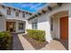 Brick pathway to covered entry with lush landscaping at 5209 Lake Overlook Ave, Bradenton, FL 34208